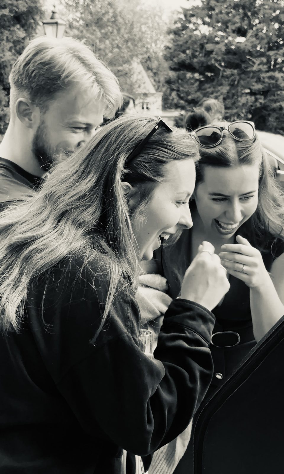 Wedding guests laughing as they watch their 360 video back